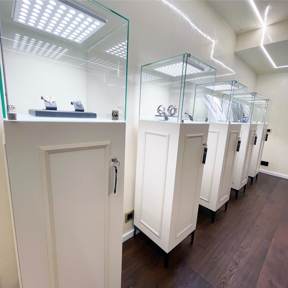 a row of white jewelry display cases
